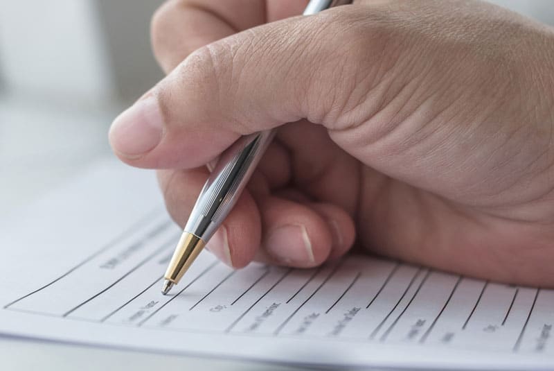 patient filling out health insurance form